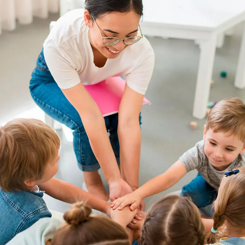 A teacher playing with her students